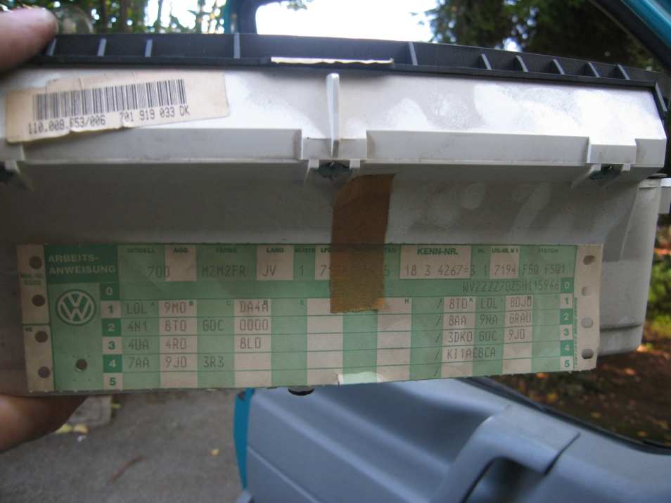 Green VW label with codes and stamps on the back of the instrument cluster