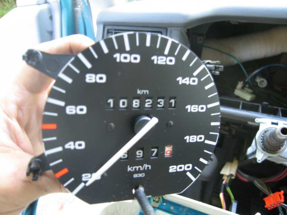 The speedometer with the odometer, just removed and held in a hand