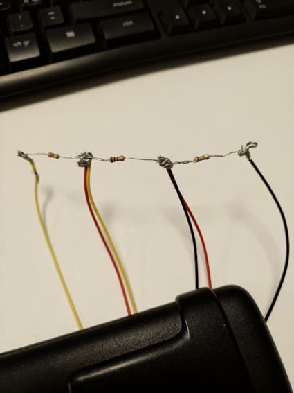 Test layout: the three resistors wired in series to the yellow, red and black wire pairs