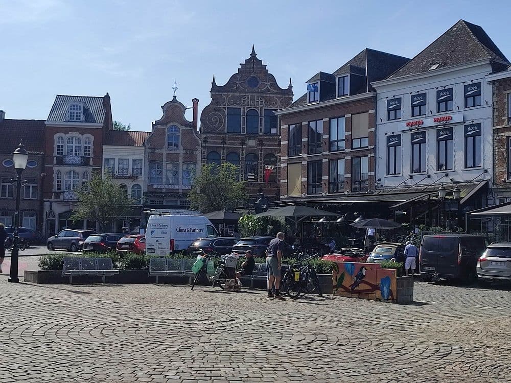 The cobbled market square of Diest, with stepped-gable houses and parked bicycles